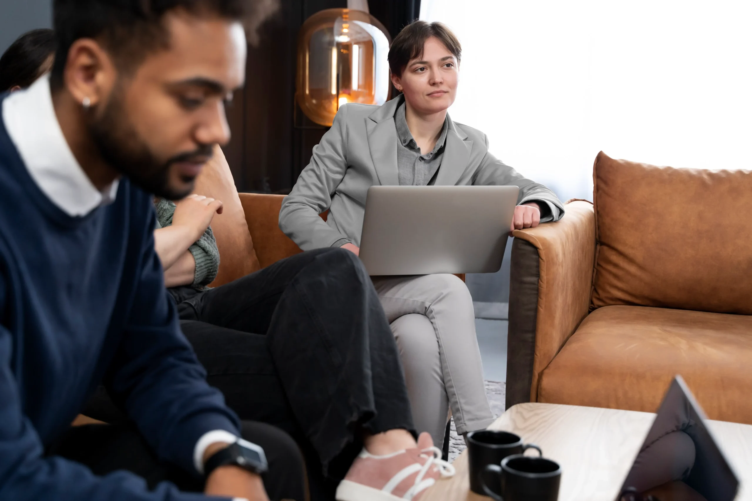 A professional attending an online sober coaching session via Zoom from a comfortable office setting